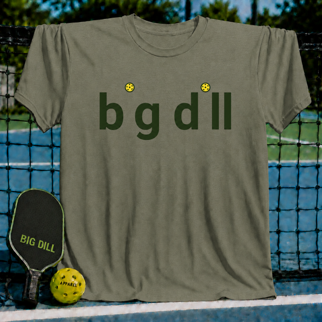 Olive green unisex t-shirt featuring a minimalist Big Dill wordmark with yellow pickleball dots on a pickleball court.