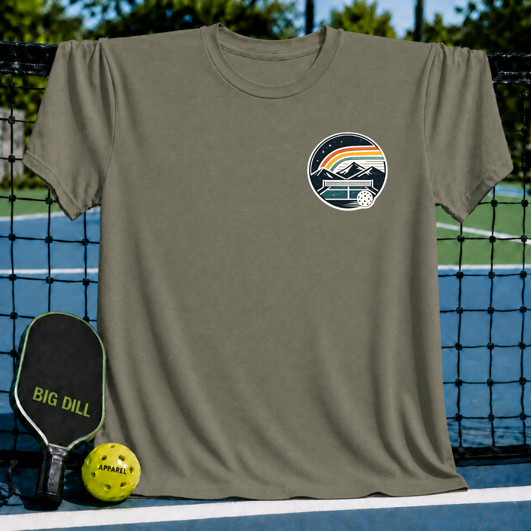 Olive green unisex t-shirt featuring a circular pickleball court crest graphic with mountains and a retro rainbow.