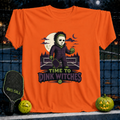 Orange unisex pickleball t-shirt featuring a spooky character holding a paddle and ball with Time to Dink Witches text.