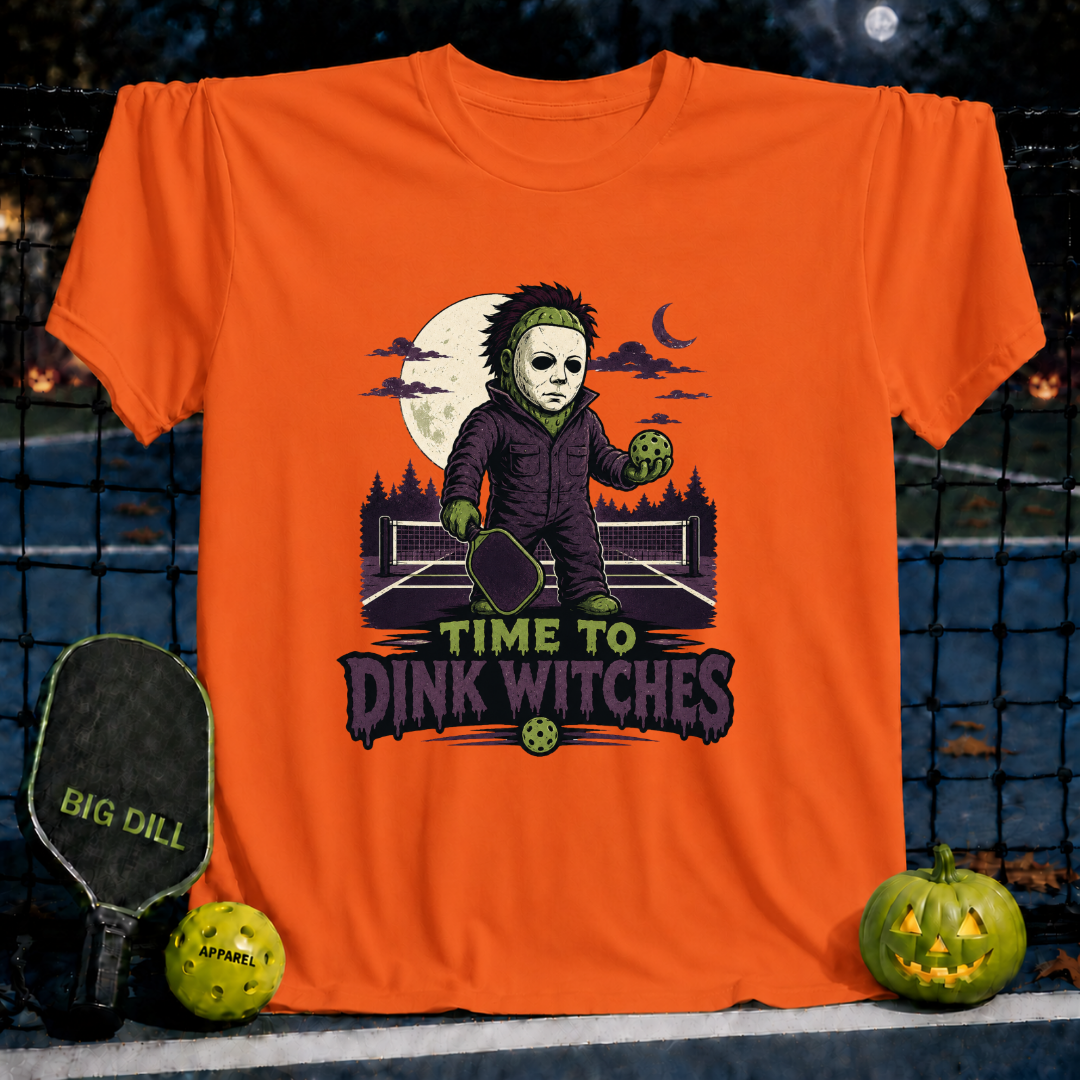 Orange unisex pickleball t-shirt featuring a spooky character holding a paddle and ball with Time to Dink Witches text.