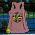 Mauve racerback tank top featuring a retro pickleball graphic, displayed on a pickleball court with paddle and ball.