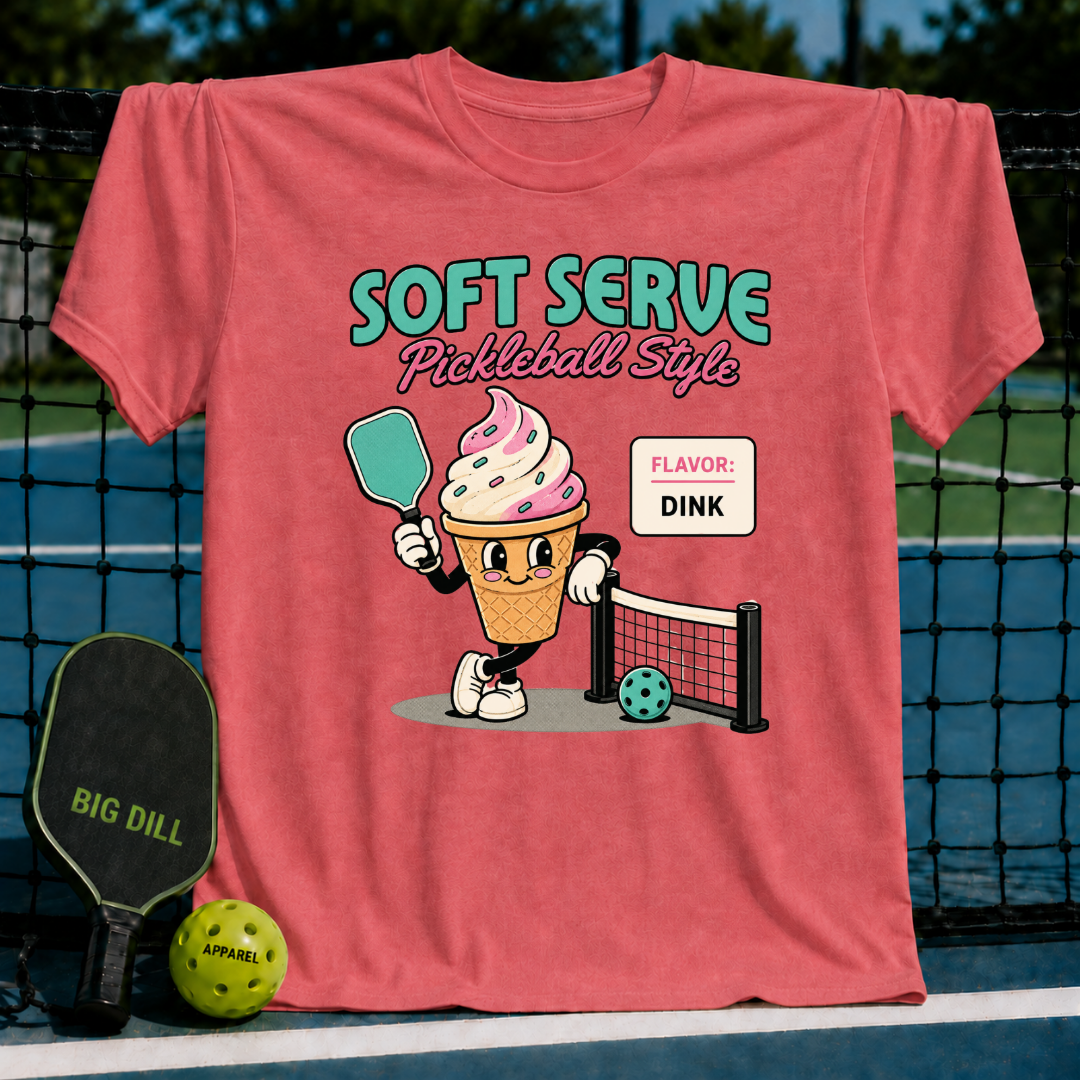 Coral unisex t-shirt featuring a retro ice cream cone character holding a pickleball paddle on a court background.