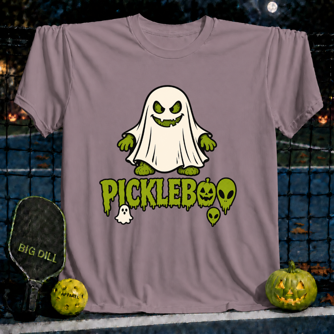 Sand-colored unisex PickleBoo t-shirt featuring a green ghost pickleball graphic with spooky text on a pickleball court.
