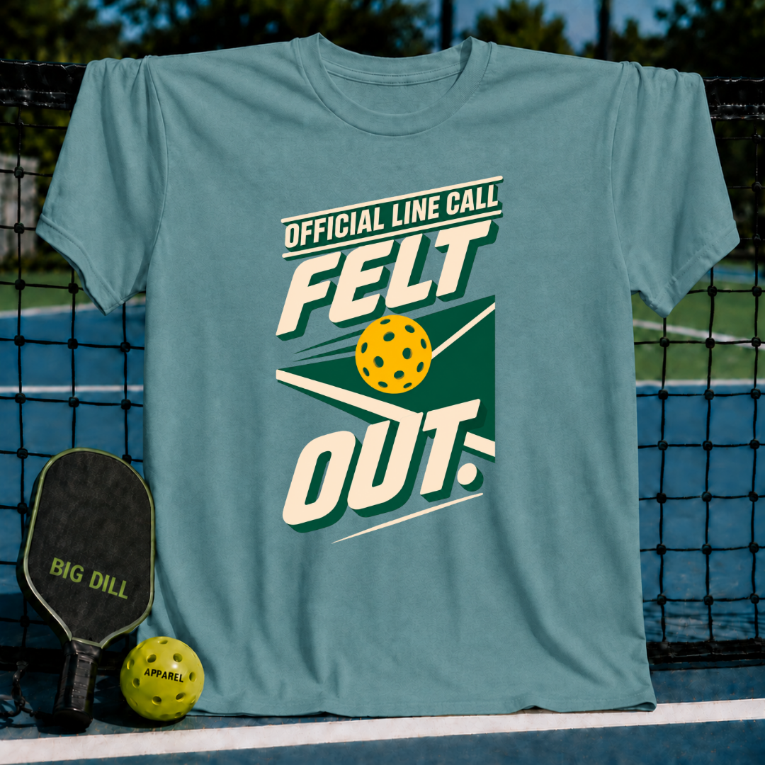 Dusty blue crewneck t-shirt featuring a pickleball-themed Official Line Call Felt Out graphic design on a court background.
