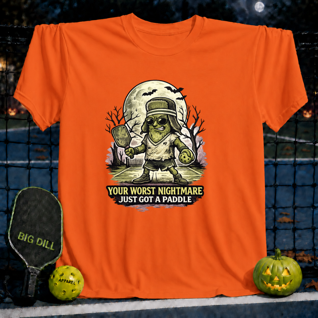 Orange unisex t-shirt featuring a Frankenstein pickleball player graphic with the text Your Worst Nightmare Just Got A Paddle.