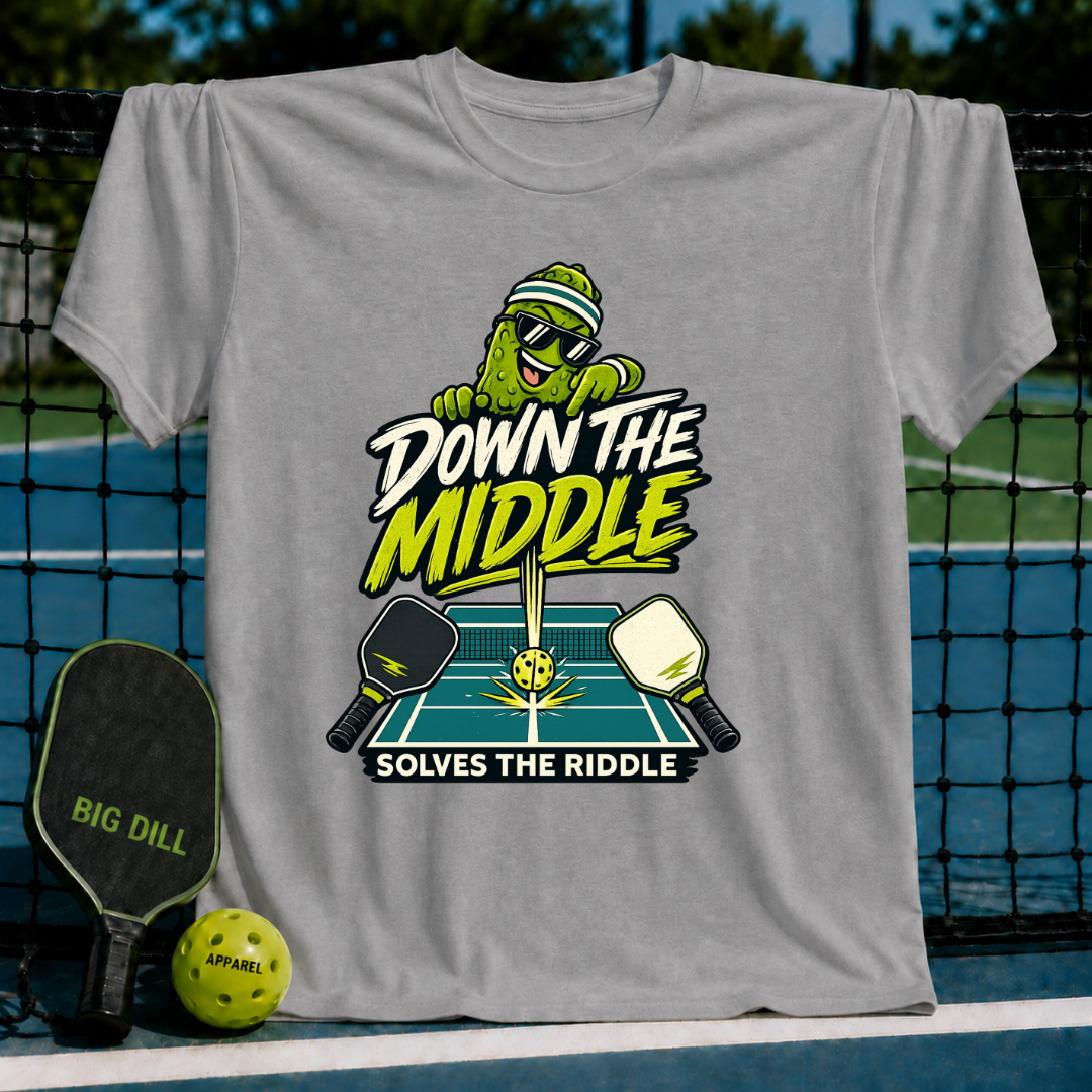 Grey crew neck t-shirt featuring a pickleball-playing pickle graphic with the text Down the Middle Solves the Riddle.