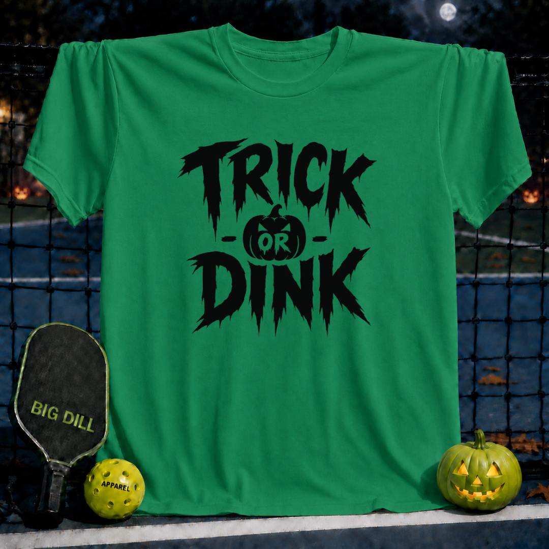 Kelly green unisex Trick-or-Dink pickleball t-shirt with black spooky text and pumpkin graphic on a court background.