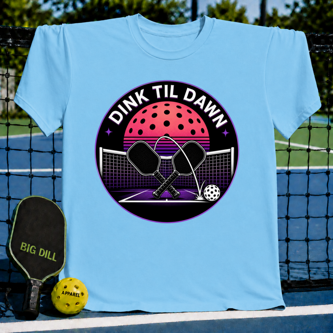 Light blue unisex t-shirt featuring a retro synthwave pickleball graphic with crossed paddles and a neon moon design.