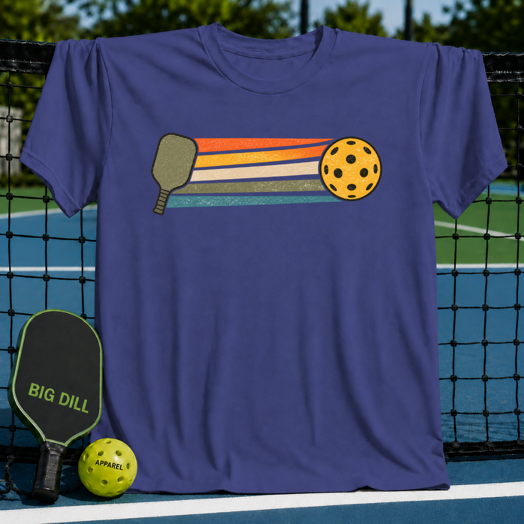 Blue unisex t-shirt featuring a retro graphic of a pickleball paddle, ball, and colorful stripes on a pickleball court.
