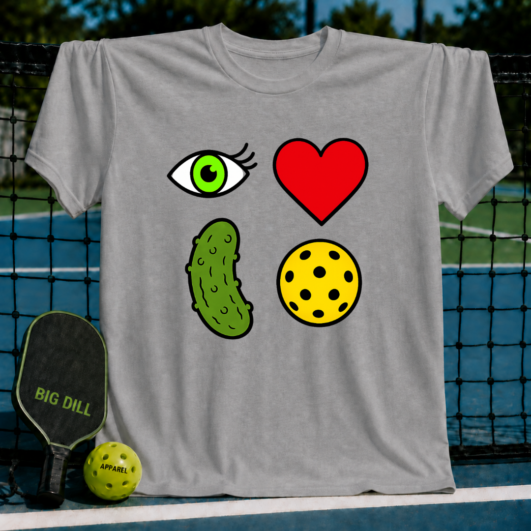 Grey unisex t-shirt featuring a 2x2 rebus graphic of an eye, heart, pickle, and ball on a pickleball court background.
