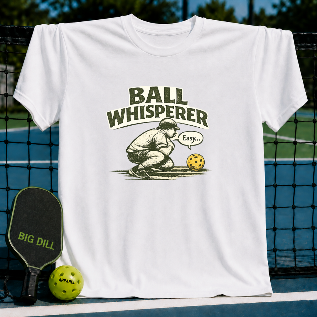 Cream unisex t-shirt featuring a vintage illustration of a player whispering to a pickleball with collegiate lettering.