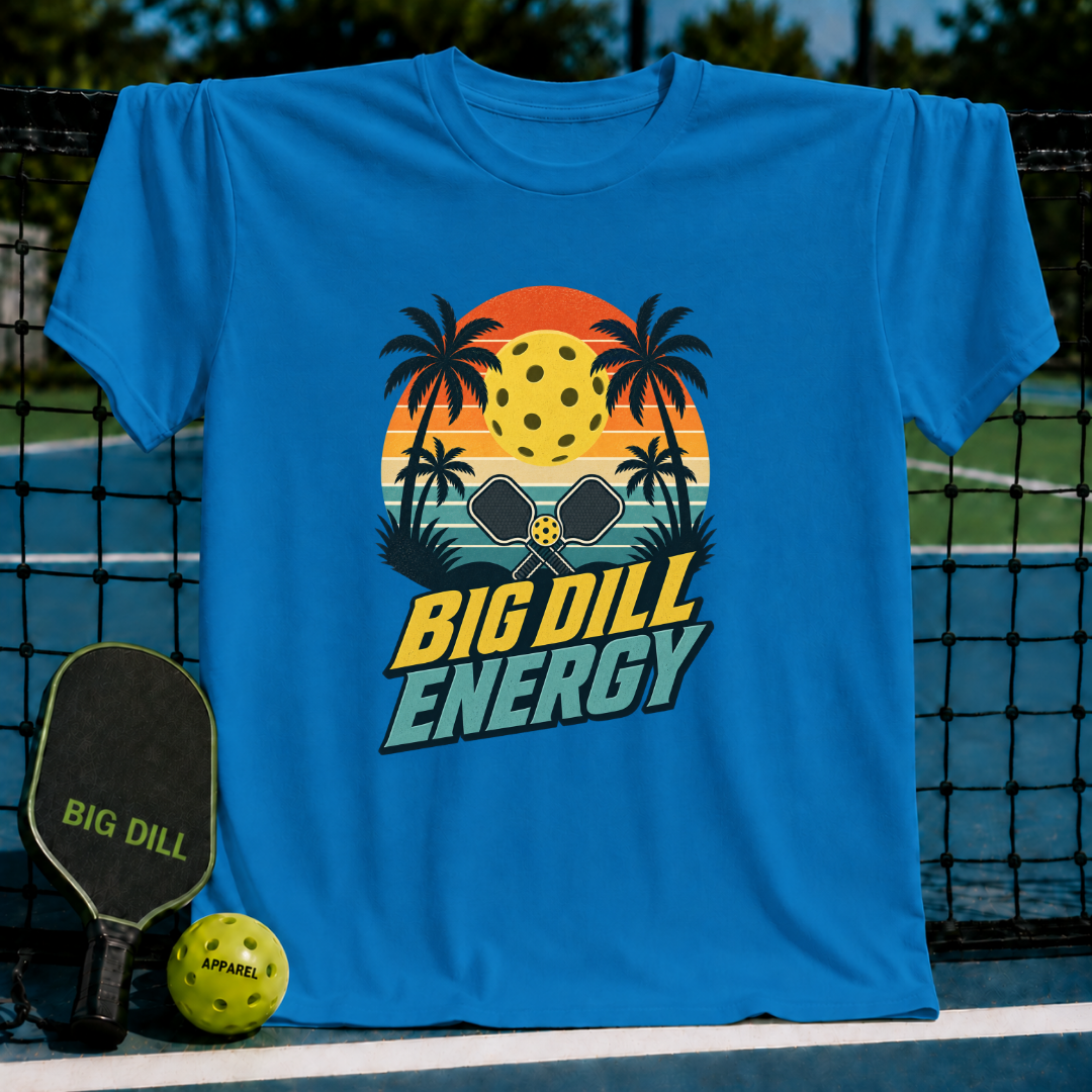 Bright blue crew neck t-shirt featuring a retro pickleball sunset graphic with palm trees and Big Dill Energy text.