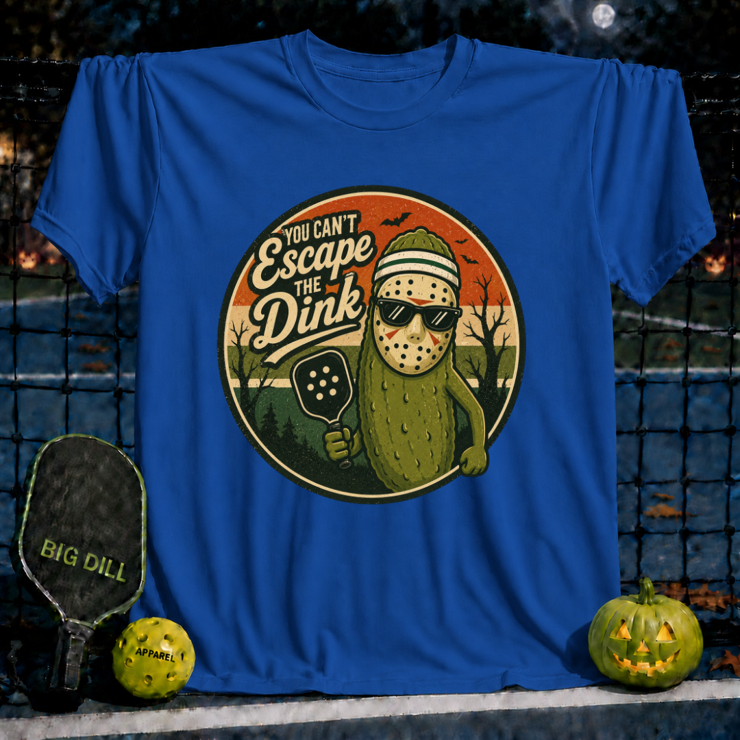 Royal blue unisex t-shirt featuring a pickleball-playing pickle wearing a hockey mask and sunglasses with the text You Can't Escape the Dink.