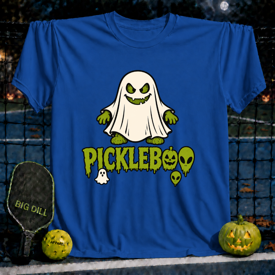 Royal blue unisex PickleBoo t-shirt featuring a spooky ghost pickle graphic, displayed on a pickleball court with a paddle.