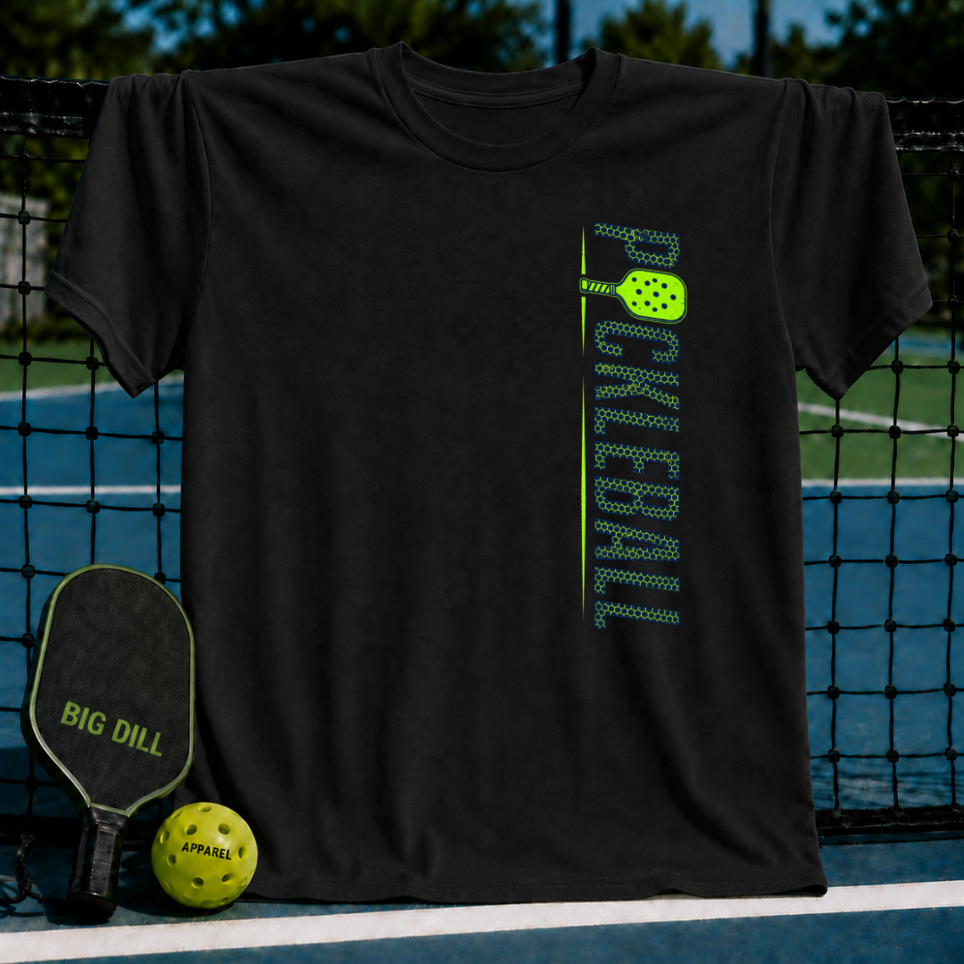 Black unisex t-shirt featuring a vertical green textured PICKLEBALL graphic with a paddle icon on a pickleball court.