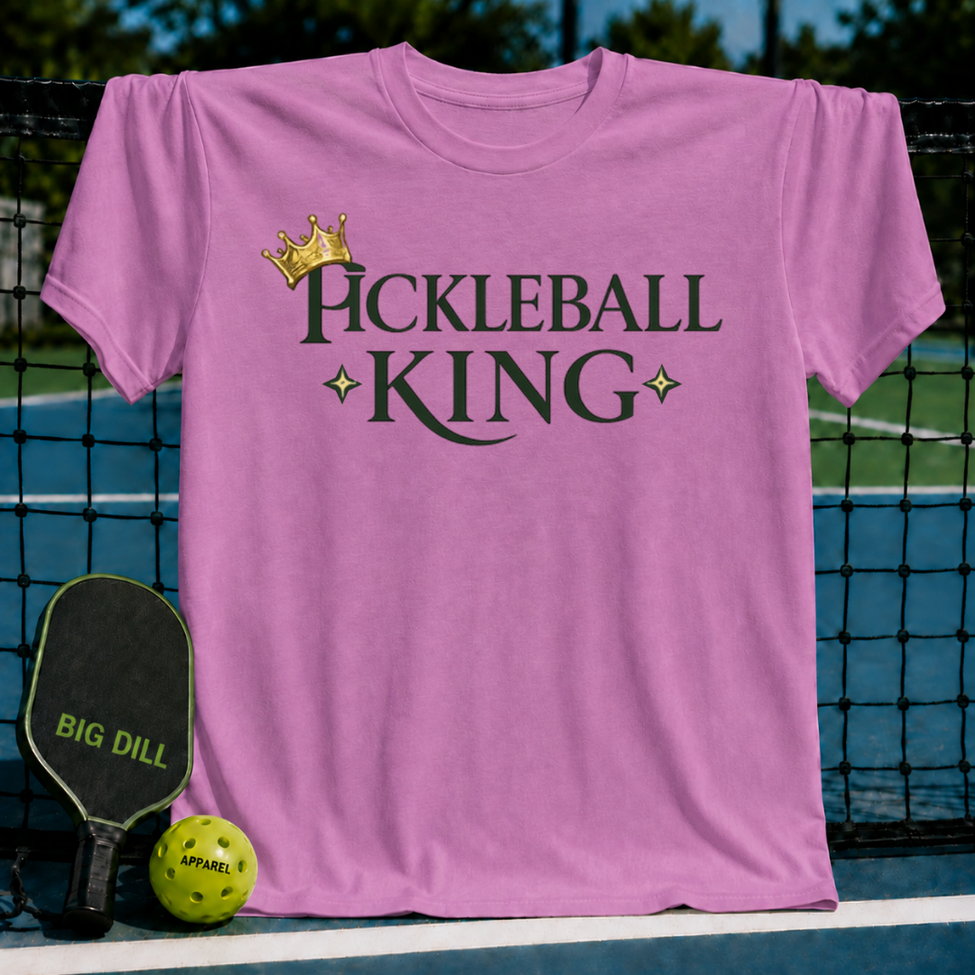 Vibrant coral unisex t-shirt featuring a gold crown and dark olive Pickleball King text with star accents.