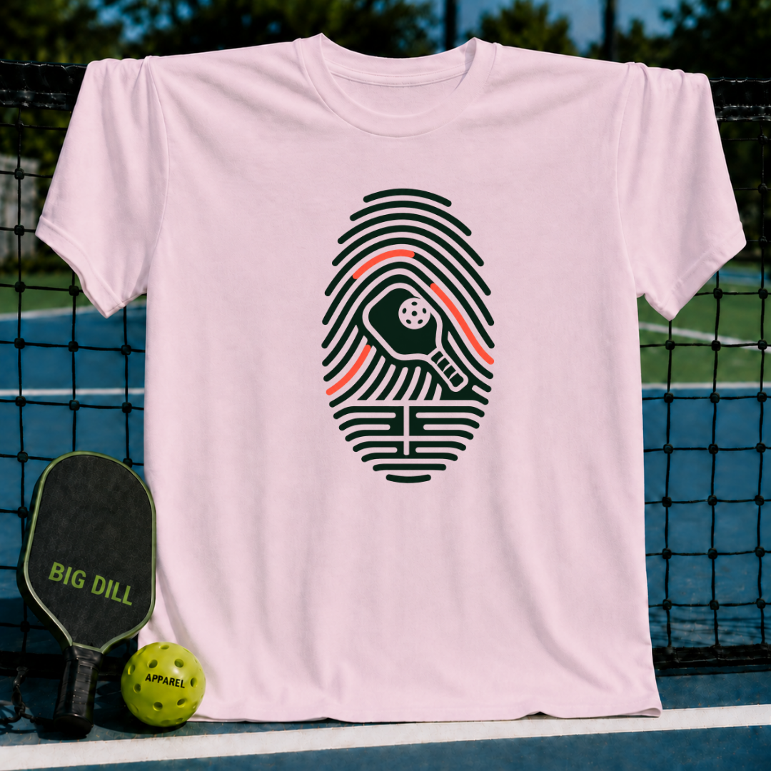 Light pink cotton t-shirt featuring a black fingerprint graphic with a pickleball paddle and ball design.