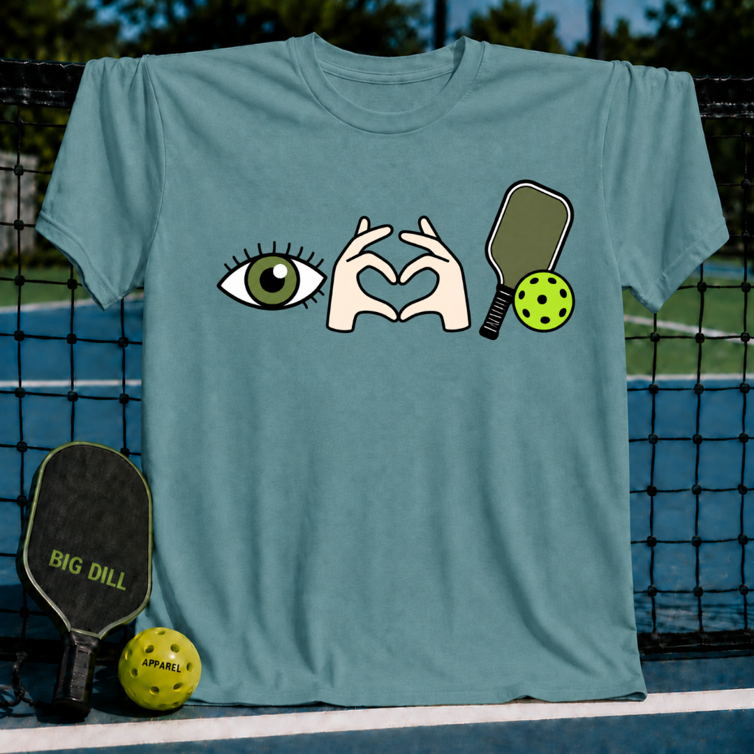 Dusty blue crewneck t-shirt featuring an eye, heart-shaped hands, and pickleball paddle graphic.
