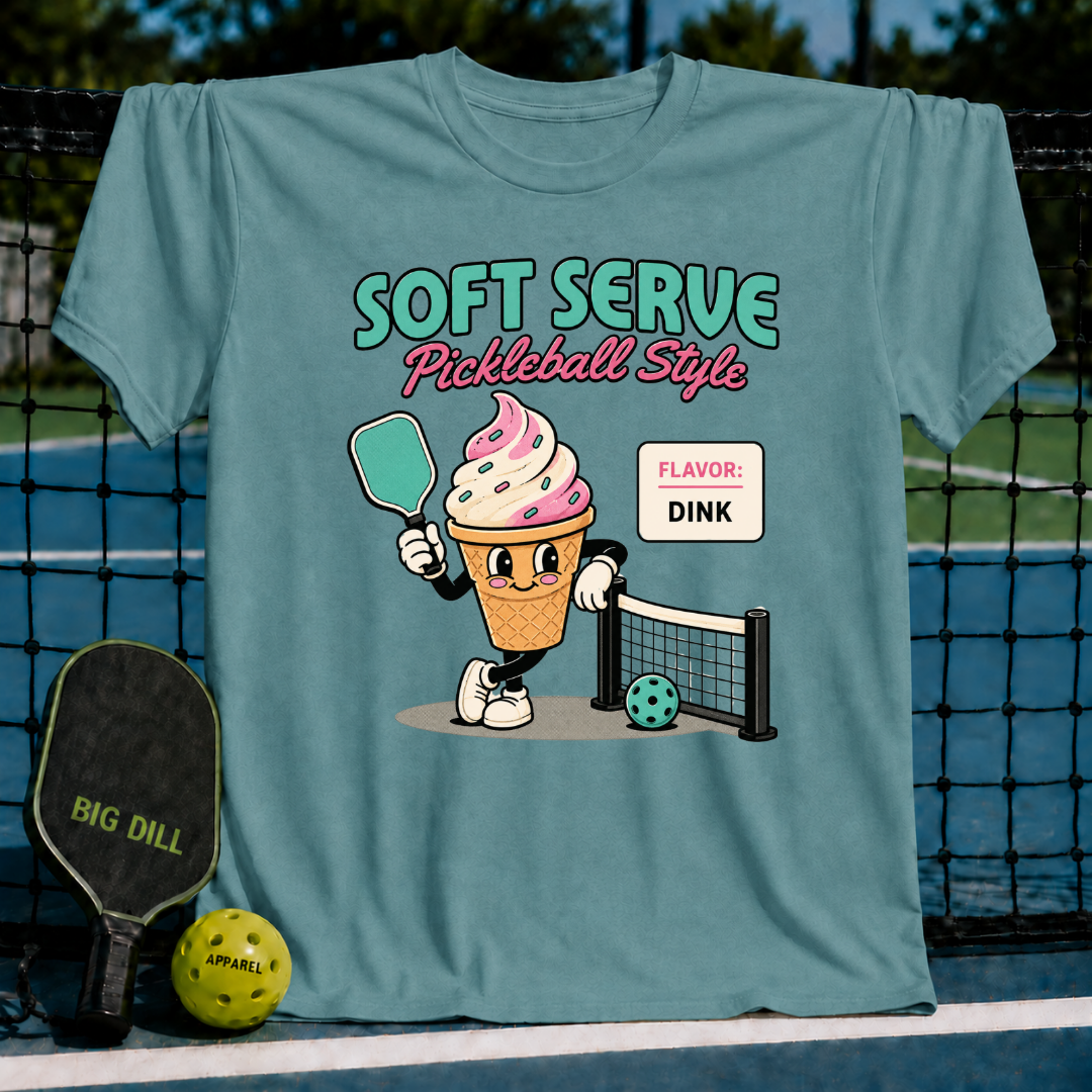 Teal unisex t-shirt featuring a retro ice cream cone character holding a pickleball paddle on a court background.