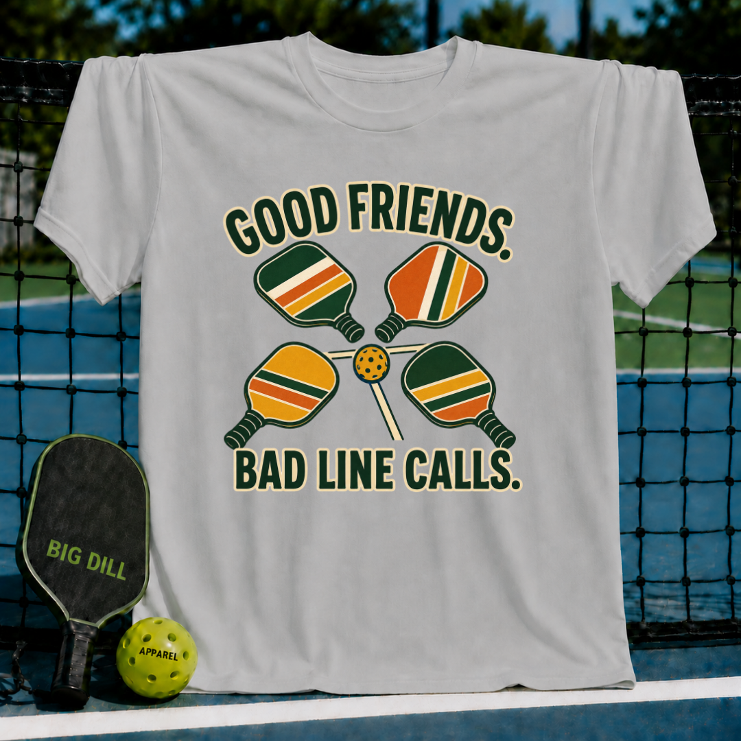Light gray crew neck t-shirt featuring a retro pickleball graphic with four paddles, a ball, and the text Good Friends Bad Line Calls.