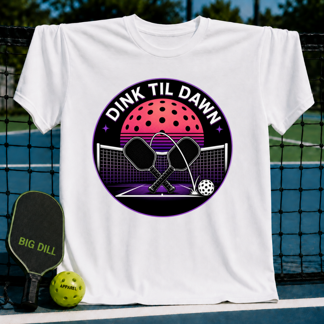 White unisex t-shirt featuring a retro synthwave pickleball graphic with crossed paddles and a neon moon on a court.