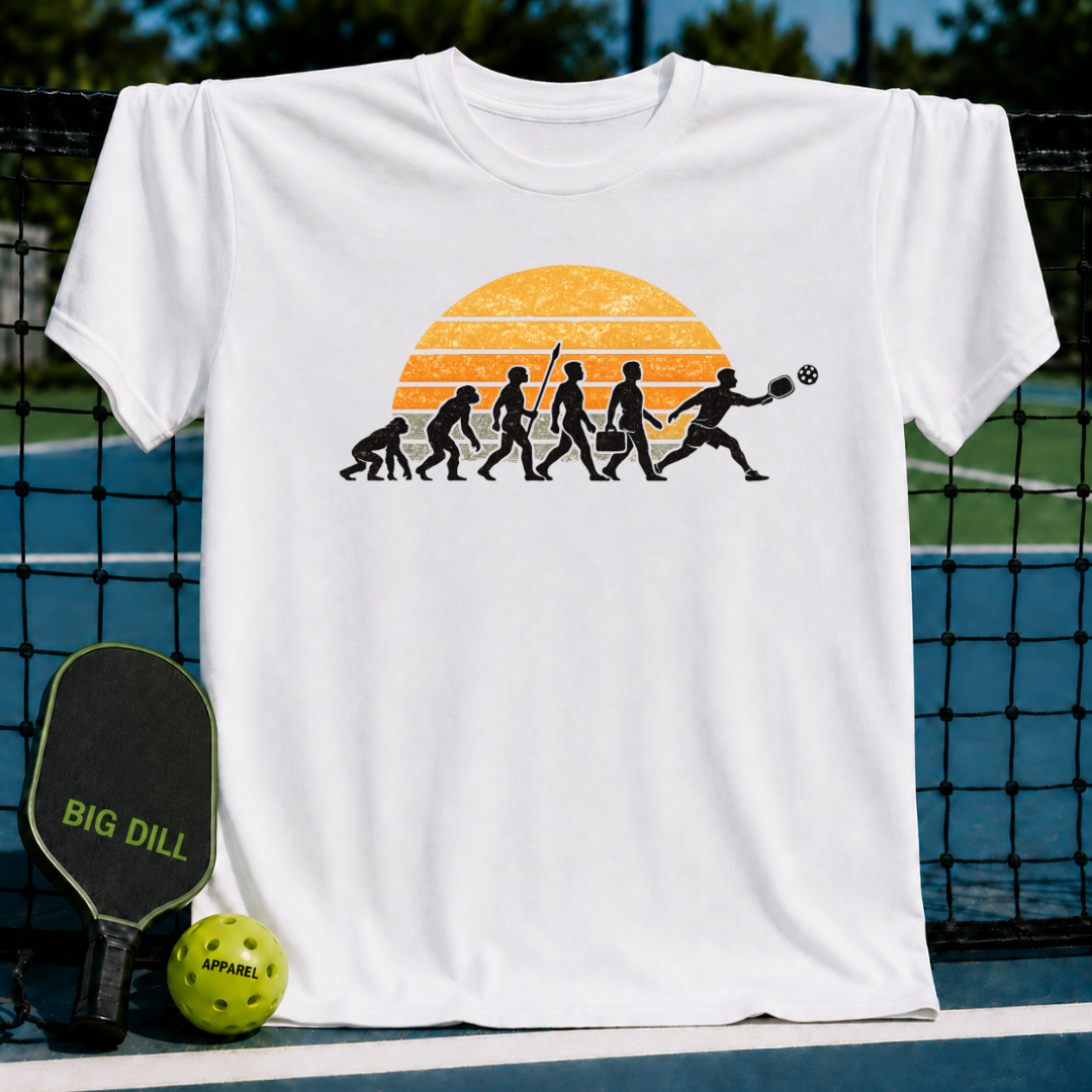 White unisex t-shirt featuring a retro sunset evolution graphic of a man playing pickleball on a court.