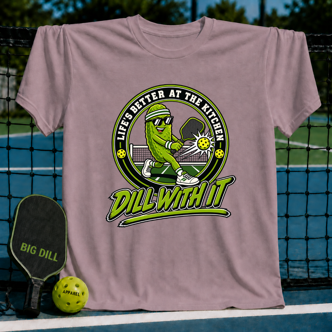 Mauve crewneck t-shirt featuring a pickleball-playing pickle graphic with the text Life's Better at the Kitchen and Dill With It.