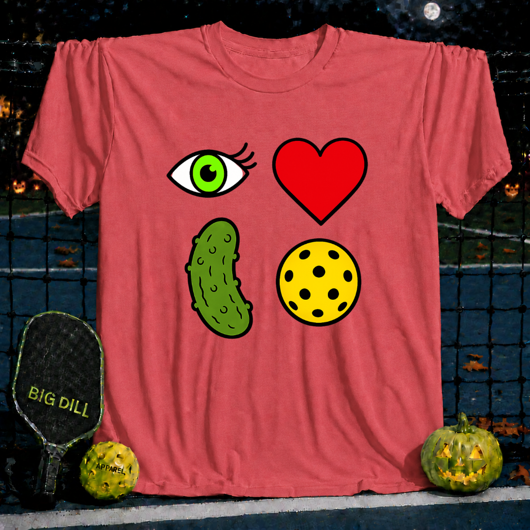 Vivid red unisex t-shirt featuring a 2x2 grid graphic of an eye, heart, pickle, and yellow pickleball on a court background.