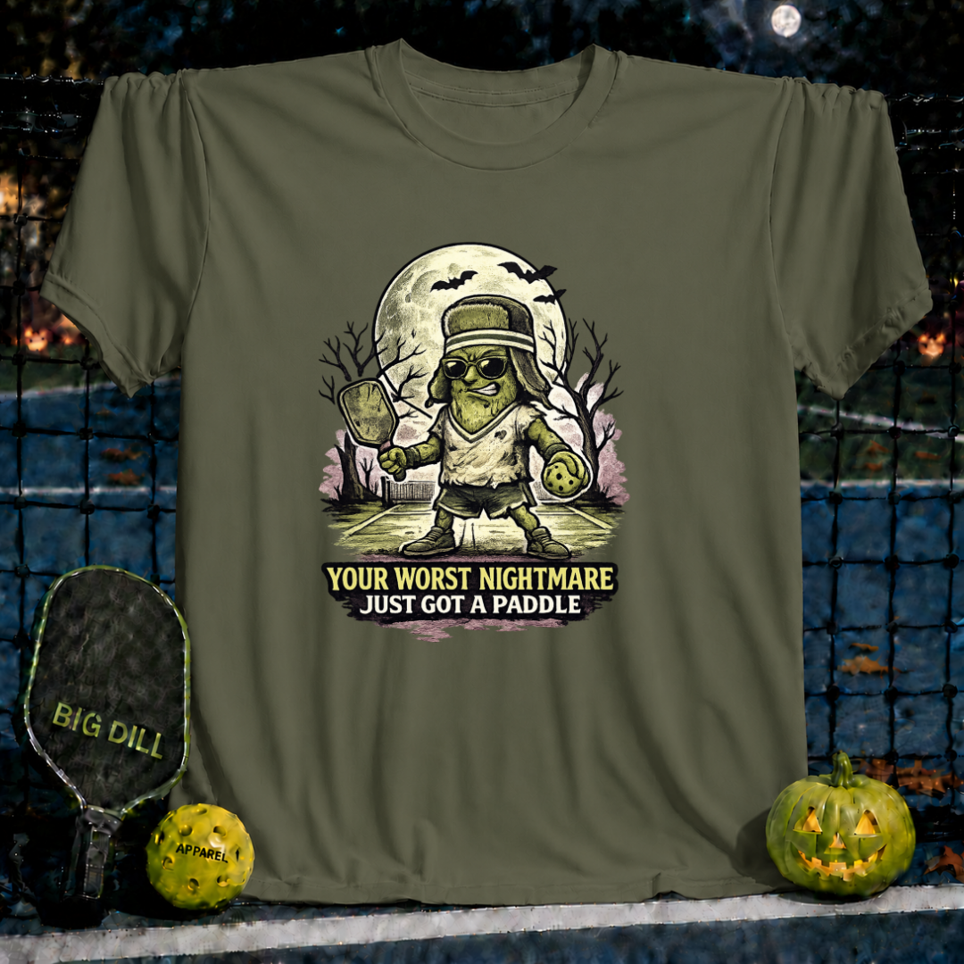 Military green unisex t-shirt featuring a spooky pickleball-playing monster graphic with the text Your Worst Nightmare Just Got A Paddle.