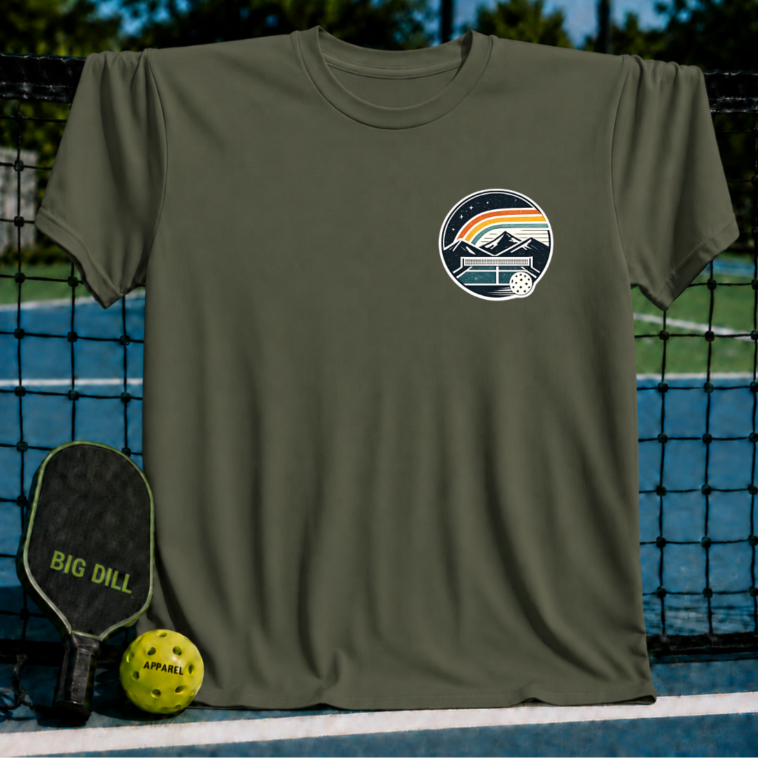 Olive green unisex t-shirt featuring a circular pickleball court crest graphic with mountains and a sunset design.