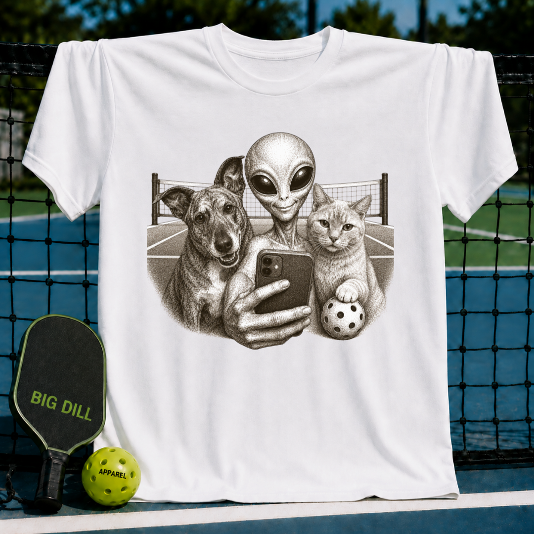 White unisex t-shirt featuring a vintage-style illustration of an alien, dog, and cat taking a selfie on a pickleball court.