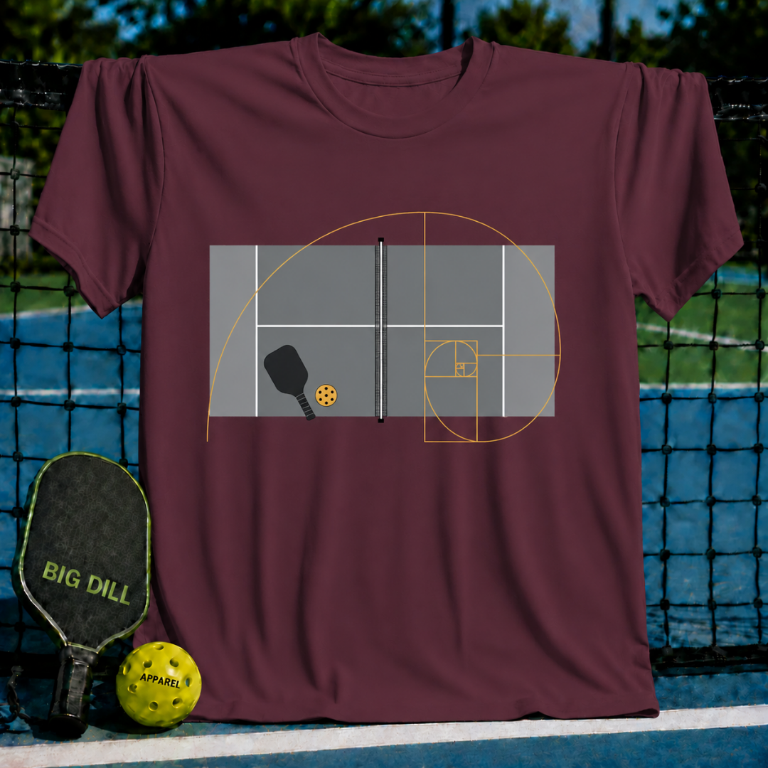 Maroon crewneck t-shirt featuring a golden ratio spiral graphic overlaid on a pickleball court diagram with paddle and ball.