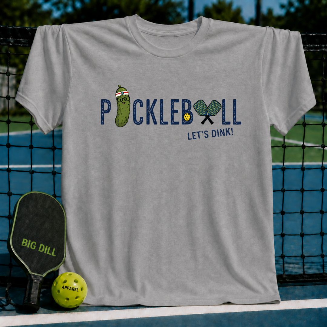 Light gray crewneck t-shirt featuring a Pickleball Let's Dink graphic with a pickle character and paddles on a court.