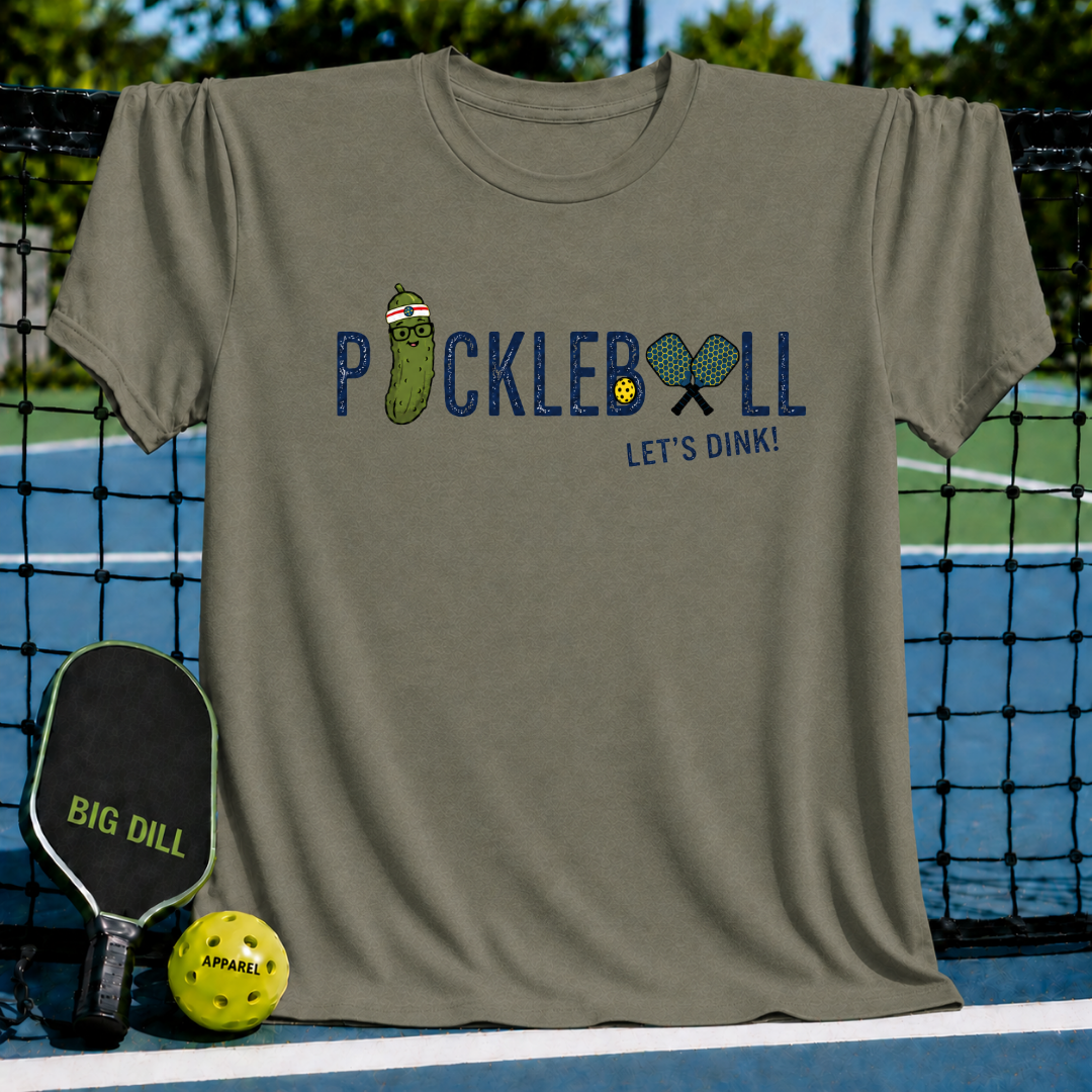 Olive green crewneck t-shirt featuring a Pickleball Let's Dink graphic with a pickle character and paddles on a court.
