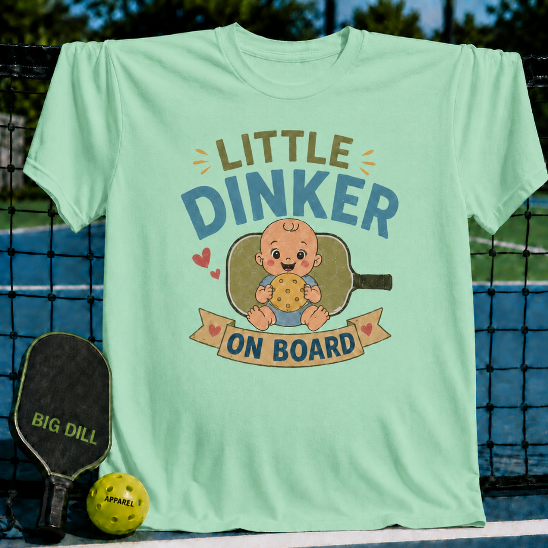 Light green maternity t-shirt featuring a Little Dinker On Board graphic with a baby and pickleball paddle design.