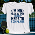 White unisex t-shirt featuring distressed navy blue text that reads I'm Not Here To Win, I'm Only Here To Complain.