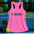 Pink racerback tank top with Pickleball graphic, displayed on a court with a paddle and ball.