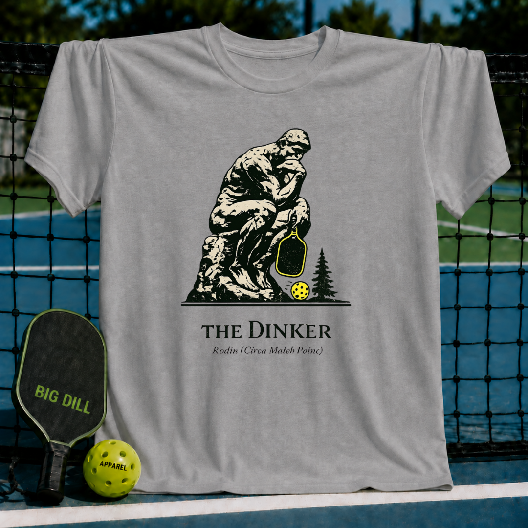 Grey unisex t-shirt featuring The Thinker holding a pickleball paddle with a neon yellow ball and The Dinker text graphic.
