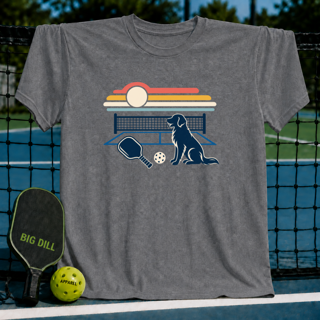 Charcoal gray crewneck t-shirt featuring a retro sunset, pickleball court, paddle, and dog graphic print.