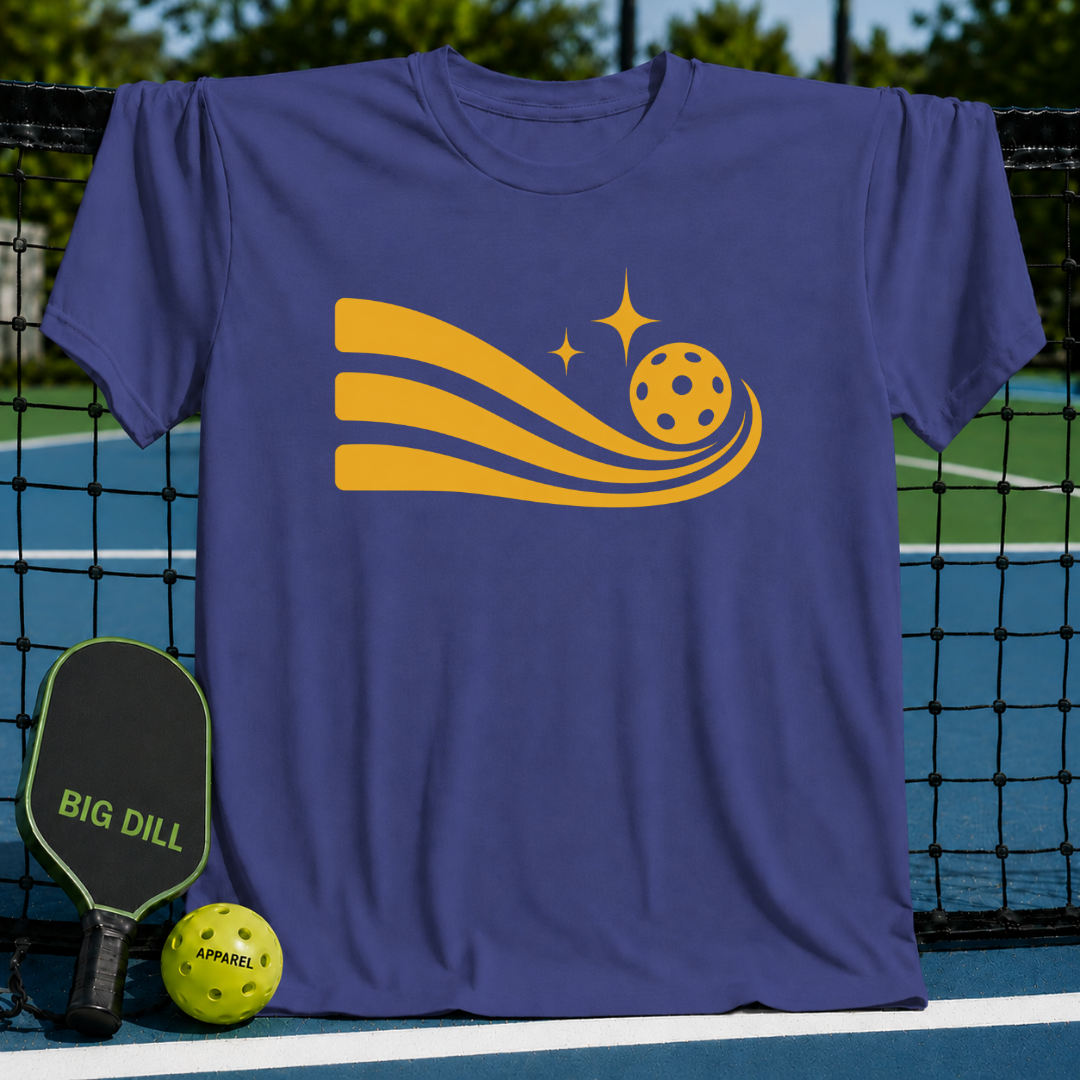 Purple unisex t-shirt featuring a gold pickleball graphic with motion trails, hanging on a pickleball court net.