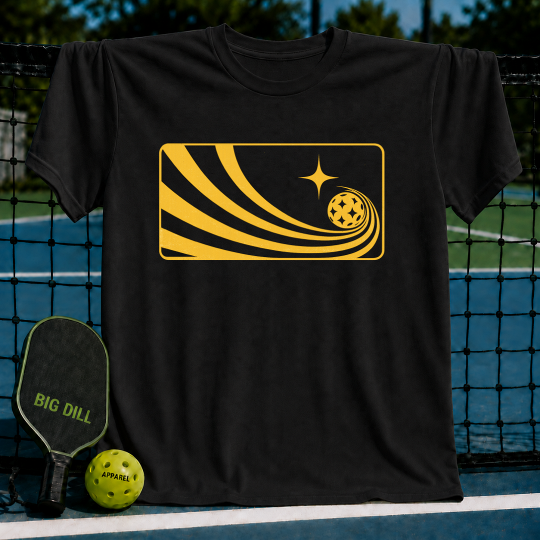 Black unisex T-shirt featuring a yellow graphic of a pickleball with a comet-like trail on a pickleball court background.