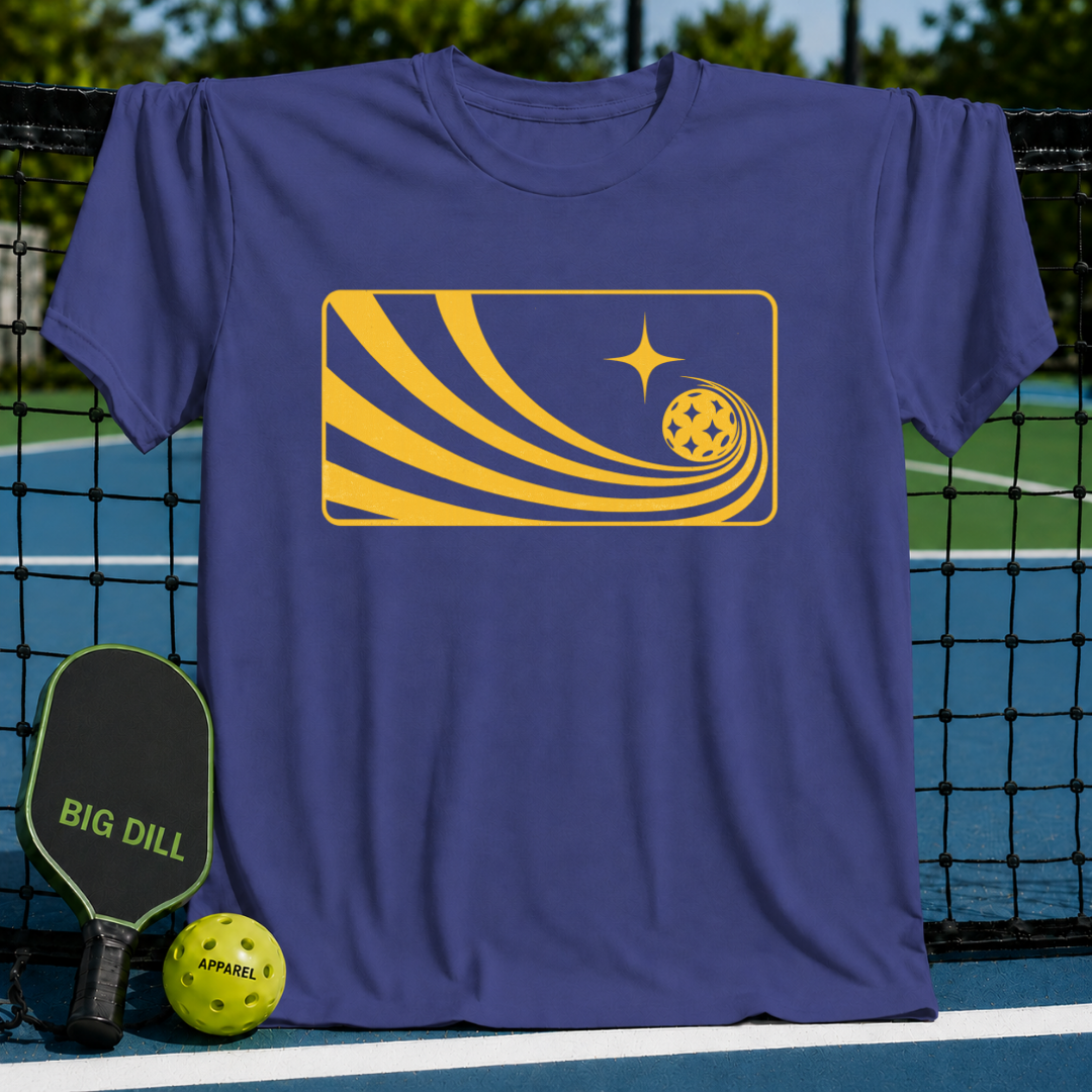 Blue unisex Solar Flow T-shirt featuring a yellow graphic of a pickleball with a comet-like trail on a pickleball court.