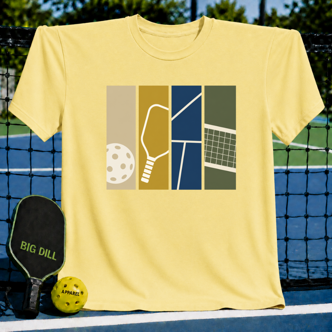 Light yellow crew neck t-shirt featuring a graphic print of a pickleball, paddle, court, and net in vertical panels.