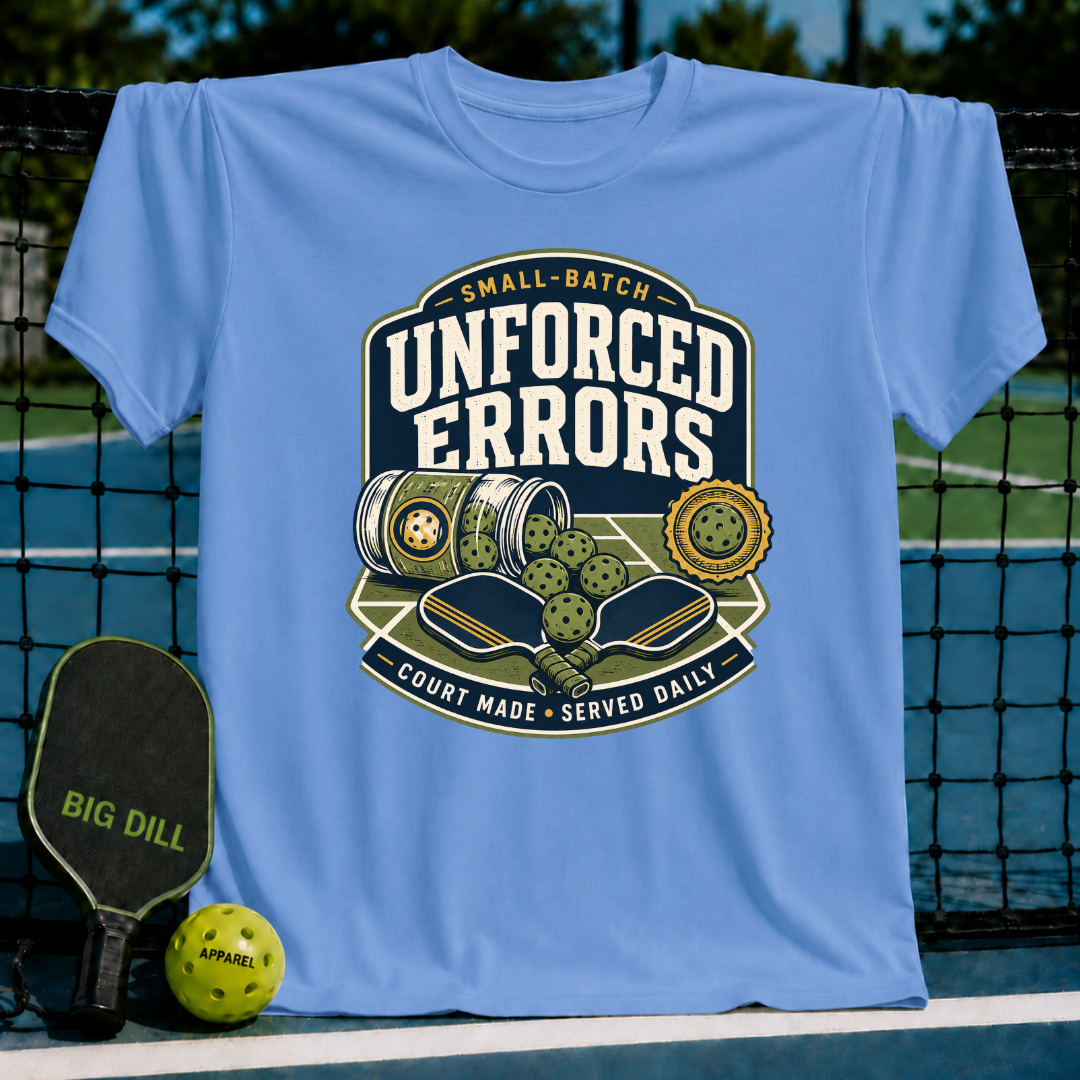 Light blue crew neck t-shirt featuring a vintage-style pickleball graphic with paddles, balls, and Unforced Errors text.