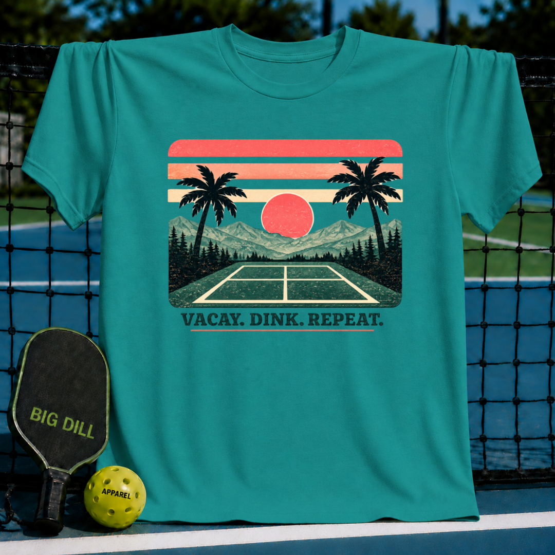 Teal crewneck t-shirt featuring a retro sunset pickleball court graphic with the text Vacay. Dink. Repeat.
