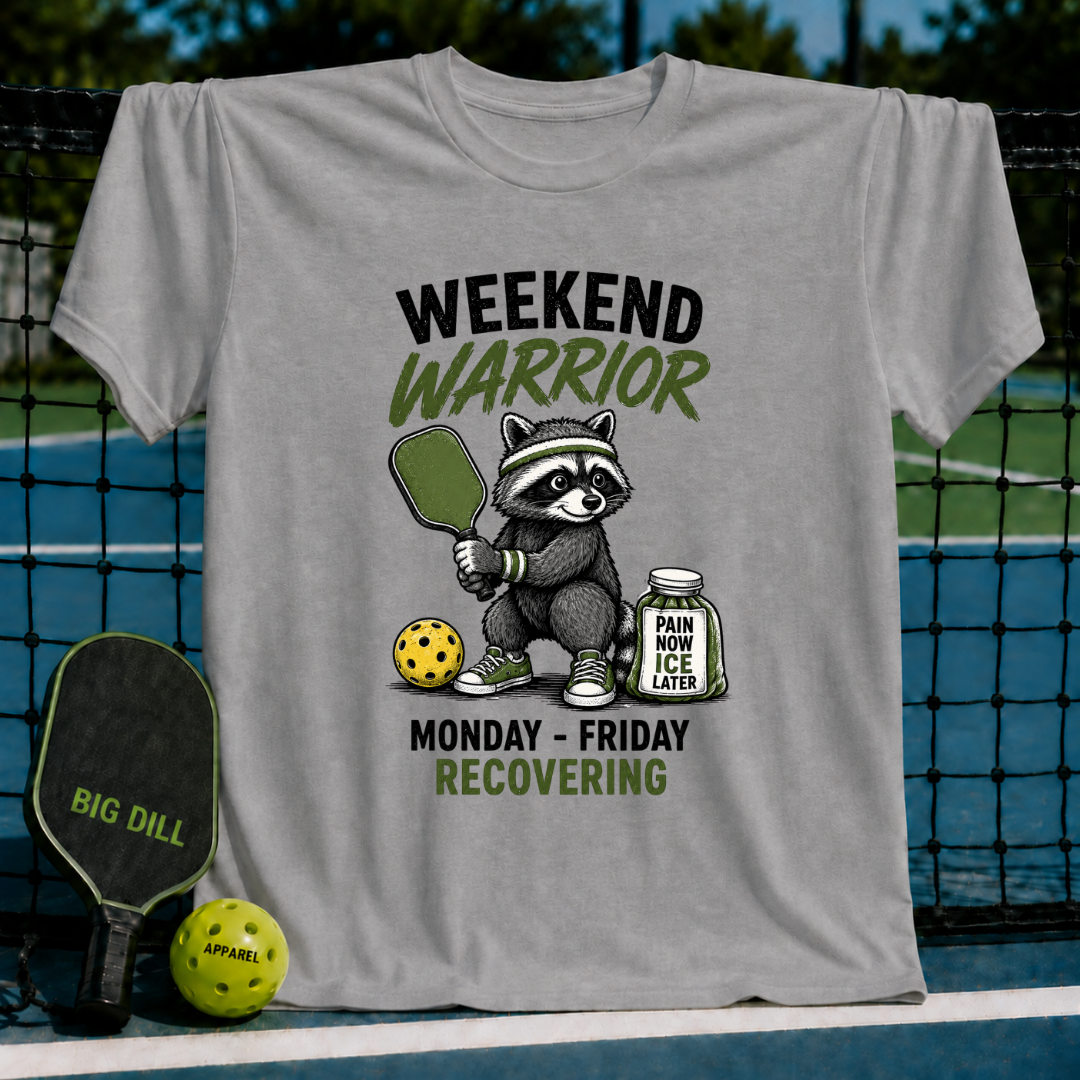 Grey t-shirt featuring a raccoon pickleball player with a paddle, ball, and ice jar, with Weekend Warrior text.
