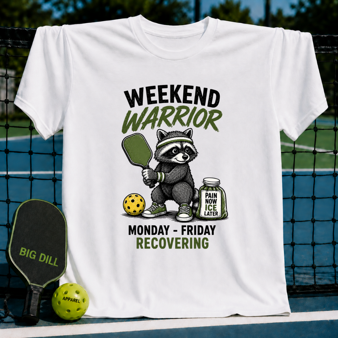 White unisex t-shirt featuring a raccoon warrior with a pickleball paddle, ball, and ice jar graphic.